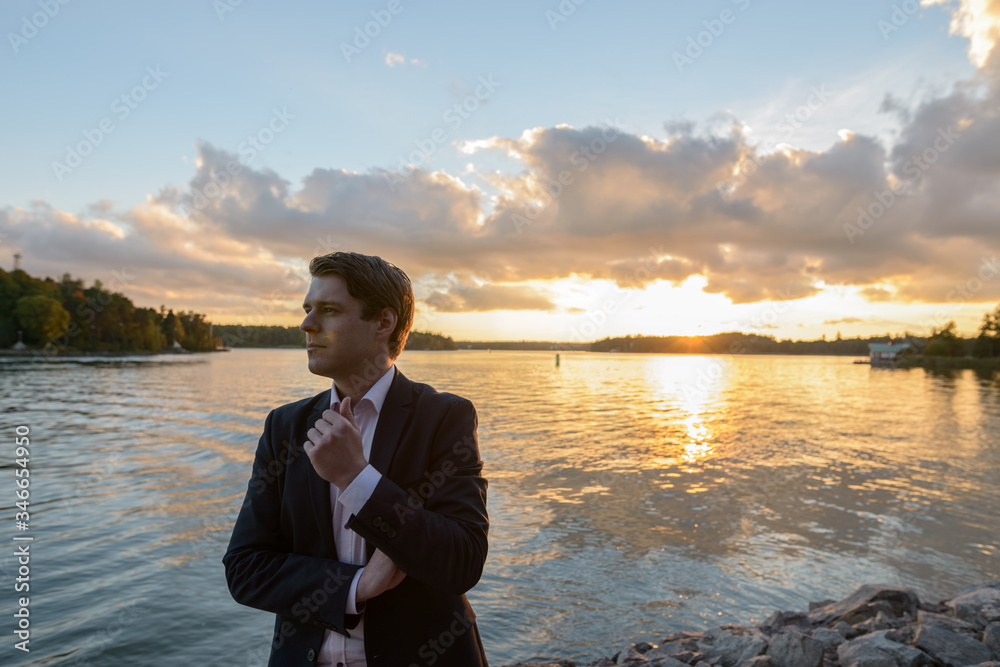 Young businessman thinking in beautiful scenic shore