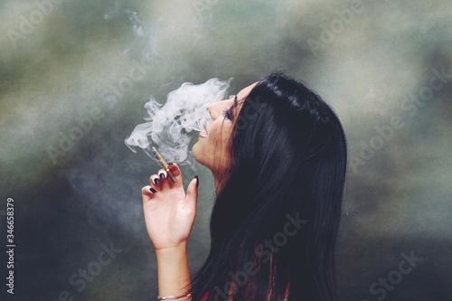 Fotografie Beautiful, fancy glamourous caucasian girl with black hair posing in studio