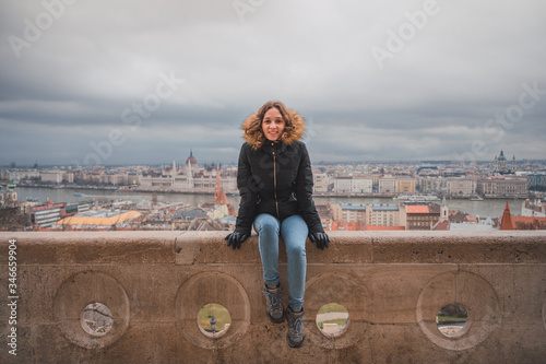 Obraz na plátně Young woman in the fishermen's bastion in Budapest, in the background the budape