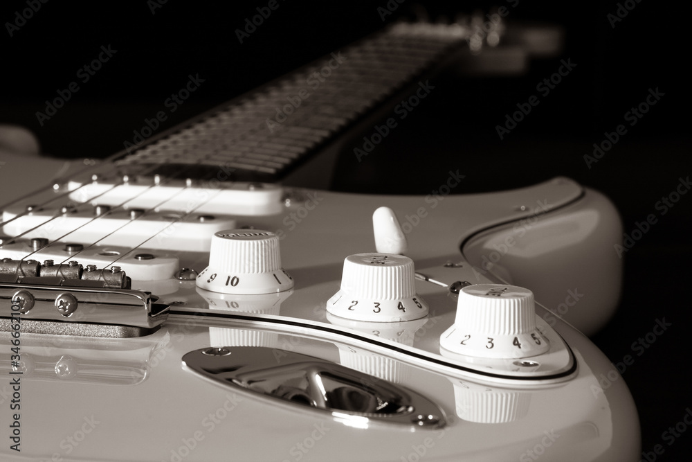 Electric guitar detail on a black background