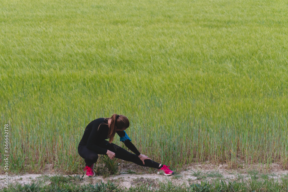 young woman doing stretching exercises outdoors young woman doing stretching exercises outdoors