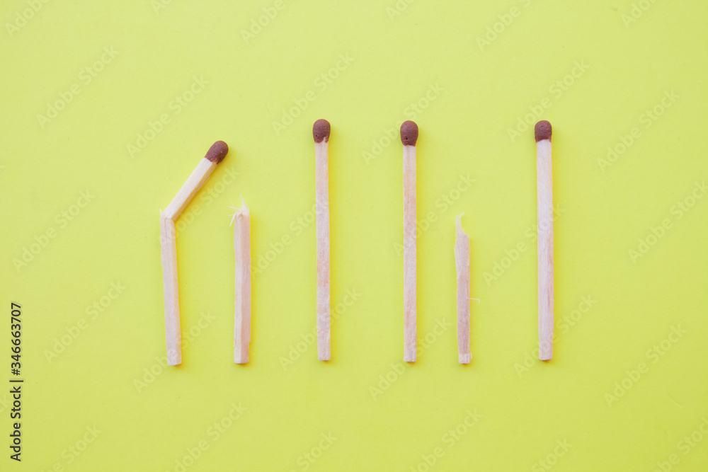 Row wooden matches yellow background,broken whole matches. Distinctive feature,broken personality,psychology concept