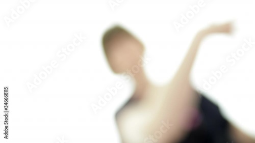 Defocused woman dancing in bright room slow motion graphic element