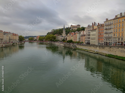 Heading into Vieux Lyon over the Pont Bonaparte. Quai Tilsitt and Quai Fulchiron on the banks of the Saone river, Passerelle, Saint Georges church and Saint-Just College on Fourviere hill, Lyon.