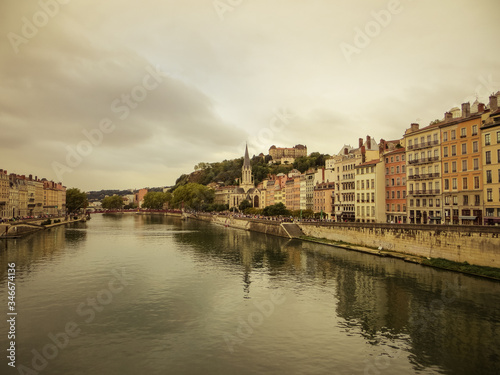 Heading into Vieux Lyon over the Pont Bonaparte. Quai Tilsitt and Quai Fulchiron on the banks of the Saone river, Passerelle, Saint Georges church and Saint-Just College on Fourviere hill, Lyon. © An Instant of Time