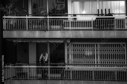 Canvas Print Man doing cycling exercise in the balcony  during coronavirus lockdown