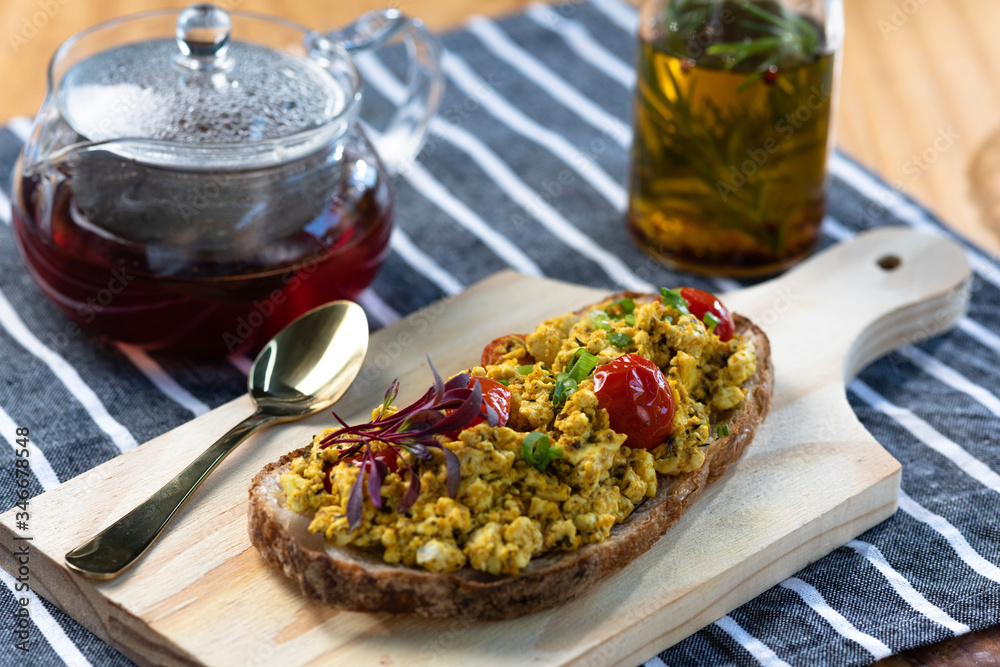 Breakfast table with natural fermentation toast and scrambled tofu. Vegan food Breakfast table with natural fermentation toast and scrambled tofu. Vegan food