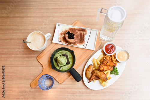 Different food is on the wooden table.