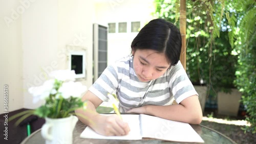 Asian girl doing homework to sent teacher at home