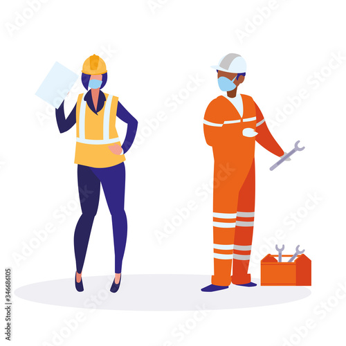 Industrial workers couple working with face mask © djvstock