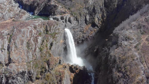 Drone Aerial View of Stunning Waterfall and Steep Rocky Canyon in Rogaland Nature Preserve, Norway photo