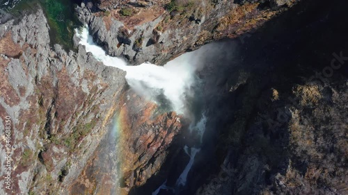 High Angle Aerial View of Glacial River Waterfall and Rainbow Above Splashes. Manafossen Fall in Picturesque Landscape of Norway photo