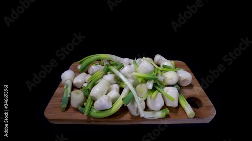 Peeled And Chopped Onions On A Wooden Cutting Board Isolated In Black Background. - pushout shot photo