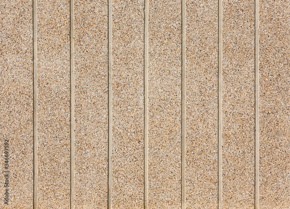 Fototapeta premium Pebbles Small stones on concrete wall.