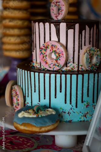 Colorful doughnuts on a birthday cake with chocolate icing