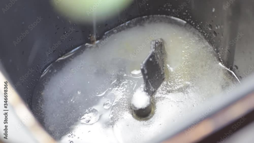 Pouring flour into a bread machine close up shot Pouring flour into a bread machine close up shot