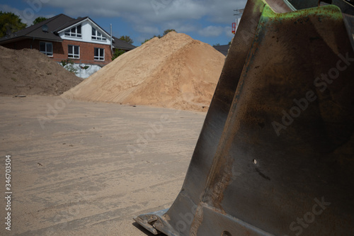 on  construction site there is a wheel loader with a shovel