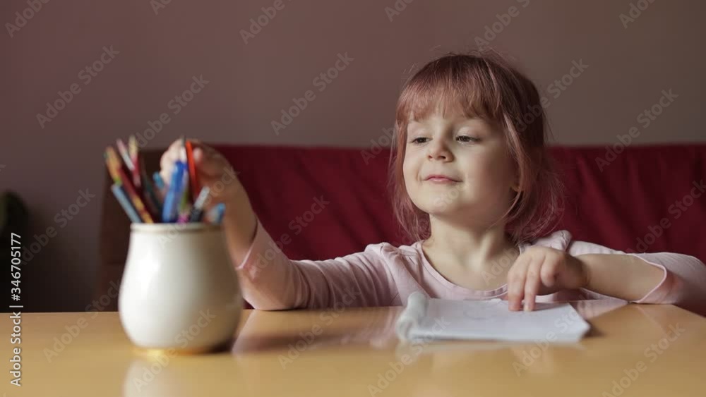 Cute child girl artist studying drawing picture with pen and pencils at home Cute child girl artist studying drawing picture with pen and pencils at home