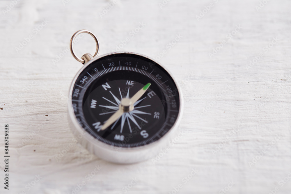 Compass On White Wooden Table Compass On White Wooden Table
