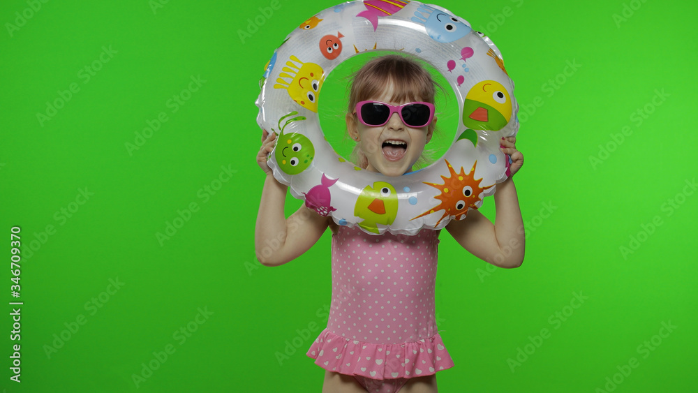 Funny child girl in swimwear play with swimming ring, make faces. Vacation sea Funny child girl in swimwear play with swimming ring, make faces. Vacation sea