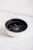 Compass On White Wooden Table