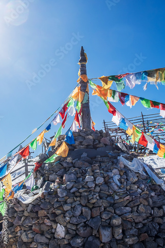 Prayer flags and stupa at the peak of Shika Snow Mountain or Blue Moon Valley, landmark and popular for tourists attractions in Zhongdian city (Shangri-La). Yunnan, China. Asia travel concept