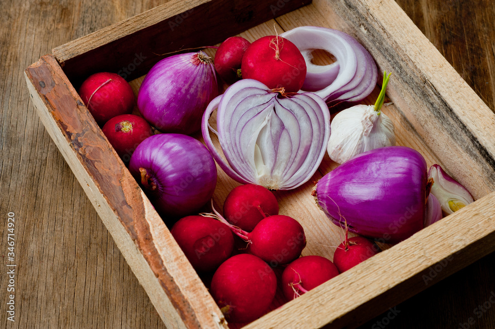 Red onion, radish and head of garlic. Background for cooking. Vegetables. Healthy nutrition, vitamins and vegetarianism. Red onion, radish and head of garlic. Background for cooking. Vegetables. Healthy nutrition, vitamins and vegetarianism.