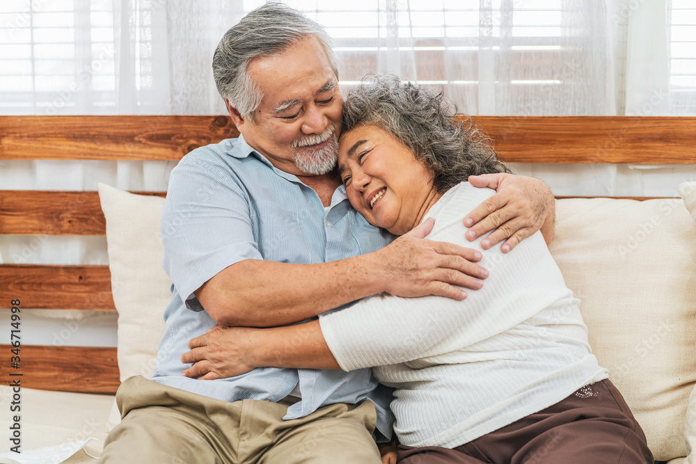 Asian couple Grandparent embracing or hugging together with happy feeling in house, romantic and lover with valentine or anniversary, Long live and Elderly society, Warm family and happiness concept