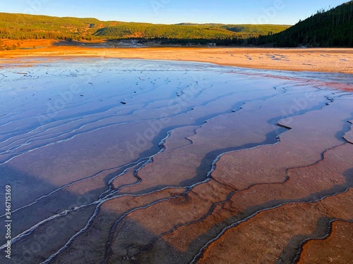 Beautiful cerulean geyser   surrounded by colorful layers of bacteria.