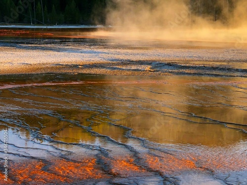 Beautiful cerulean geyser, surrounded by colorful layers of bacteria.