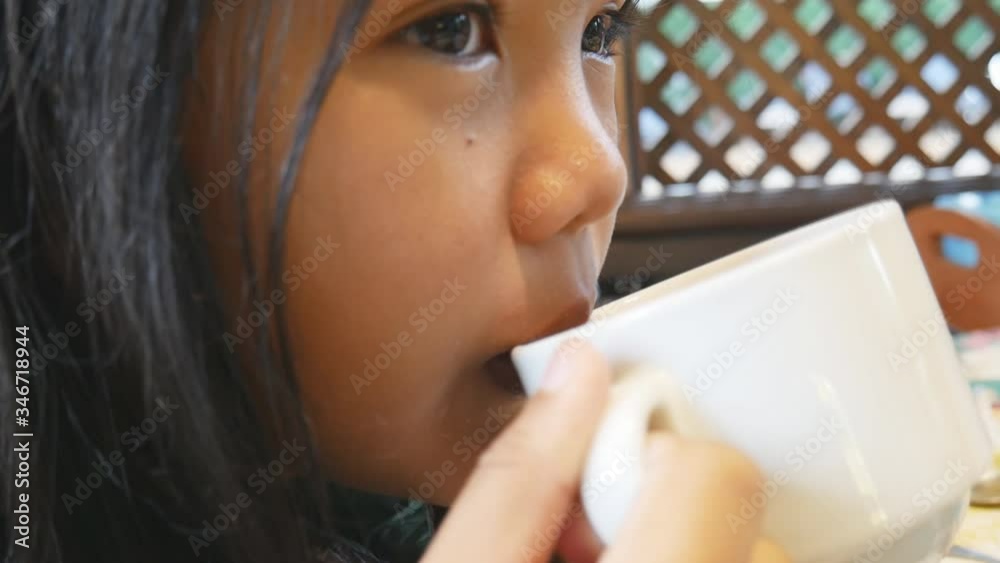 A young girl eats a delicious breakfast. A young girl eats a delicious breakfast.