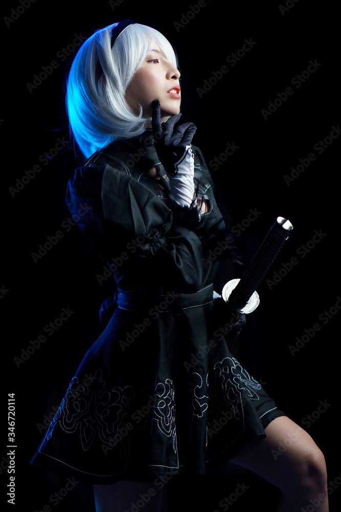 Japan anime cosplay. portrait of woman in black dress with white hair.
