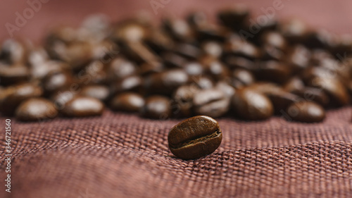 Roasted coffee beans pile on burlap