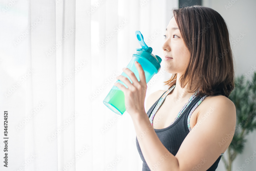 Yoga woman holding water bottle. Yoga woman holding water bottle.