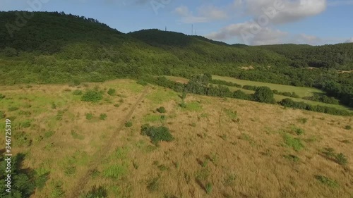 Aerial drone flight over green hill, opening beautiful panorama view at green valley with hills, mountains. Hungary, Europe 4K photo