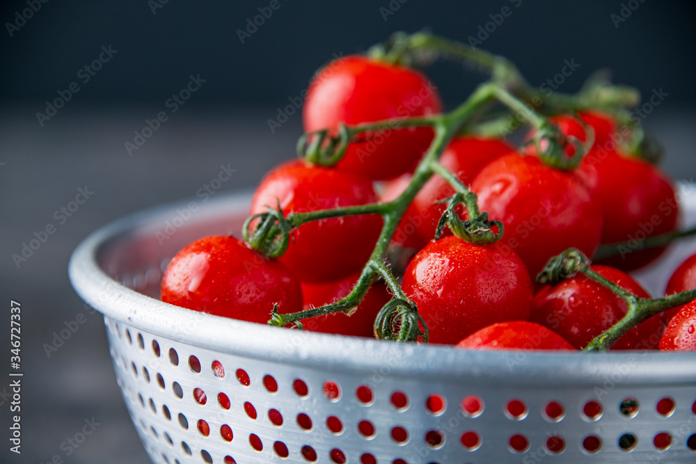 Fresh cherry tomatoes in colander. Fresh cherry tomatoes in colander.