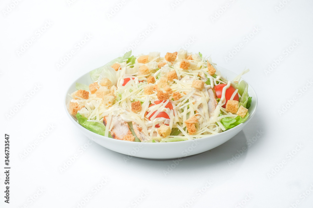 light summer salad in a white plate on a white background light summer salad in a white plate on a white background