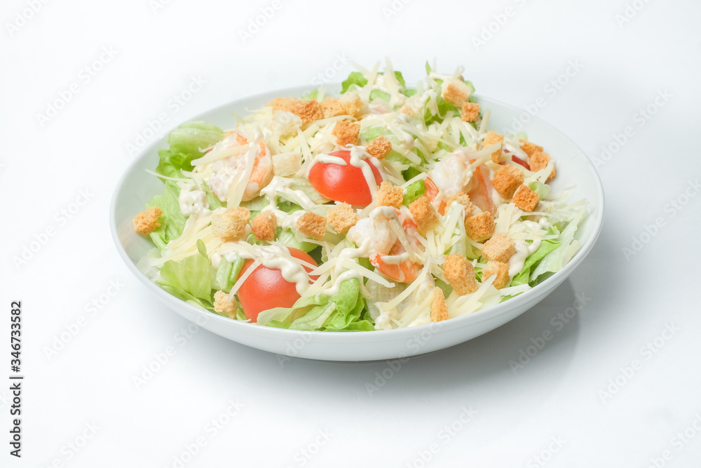 light summer salad in a white plate on a white background light summer salad in a white plate on a white background