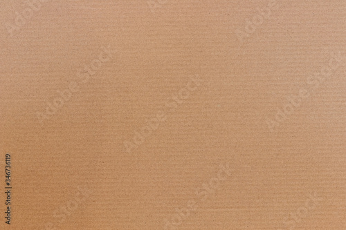 Brown cardboard background with horizontal strips, paper texture for design.
