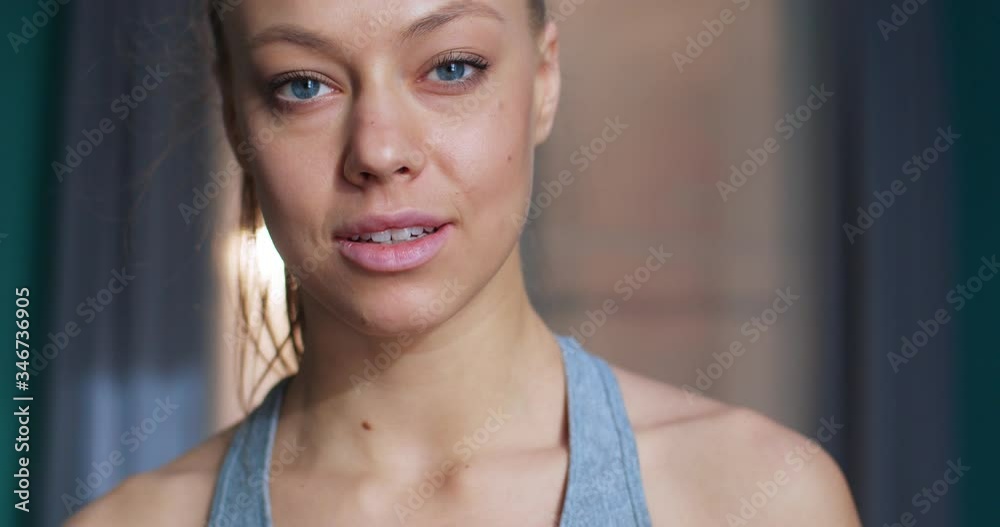 Close up portrait of happy concentrated motivated fit woman looking at camera. Young bodybuilding girl during training workout session. Sport and fitness. Training, workout and wellness concept. Close up portrait of happy concentrated motivated fit woman looking at camera. Young bodybuilding girl during training workout session. Sport and fitness. Training, workout and wellness concept.