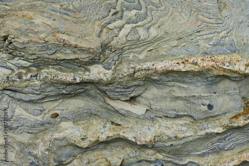 Wavy texture of gray stone closeup