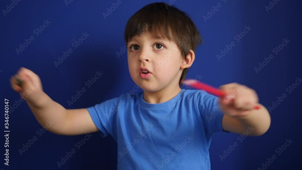 child sits at home on a sofa in a blue T-shirt plays at home during self-isolation in colored pencils child sits at home on a sofa in a blue T-shirt plays at home during self-isolation in colored pencils