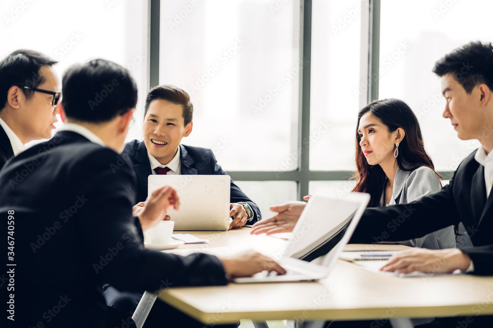 Group of asian professional business meeting and discussing with new startup idea project.Creative business people planning strategy analysis and brainstorm with document report in office.Teamwork