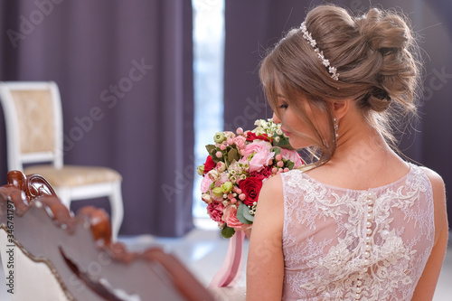 bride in a beautiful studio alone with flowers