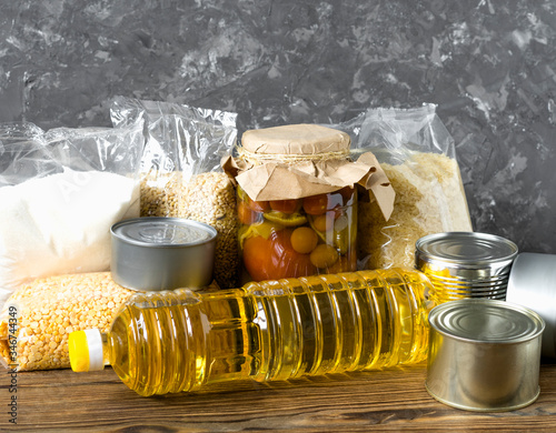 Food for donations. Healthy food for food delivery. Set of raw cereals, oil, grains and canned food.  photo