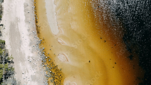 Ocean shore view from quadcopter, sand and rocks on the sea coast. Ocean day card. Ocean shore top view