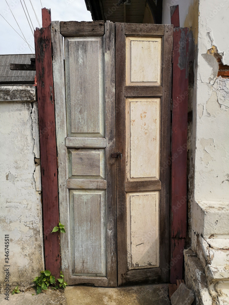 The old wooden shutters of an ancient house that deteriorated with time.