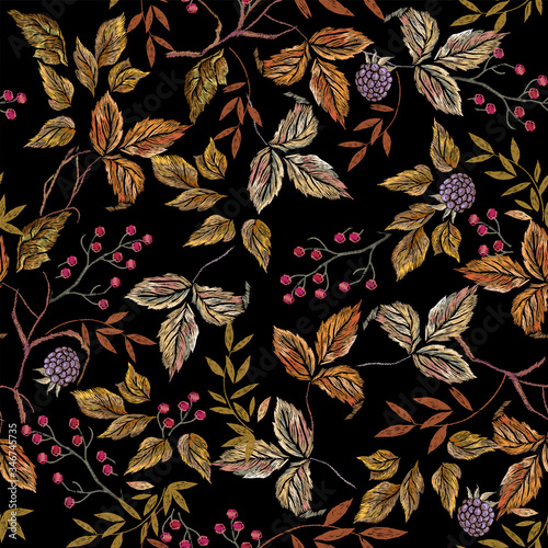 Embroider seamless floral pattern with autumn leaves and blackberry . Vector traditional embroidered bouquet with flowers on black background for clothing design.