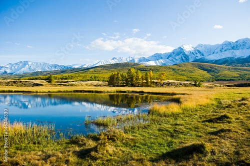 lake and mountains, Altai, autumn day. Reflections in the lake, yellow withered grass. © Dmitry Smirnov