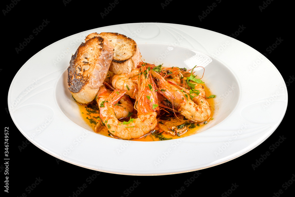 Gourmet shrimp with butter and garlic on a plate, isolated on black background Gourmet shrimp with butter and garlic on a plate, isolated on black background